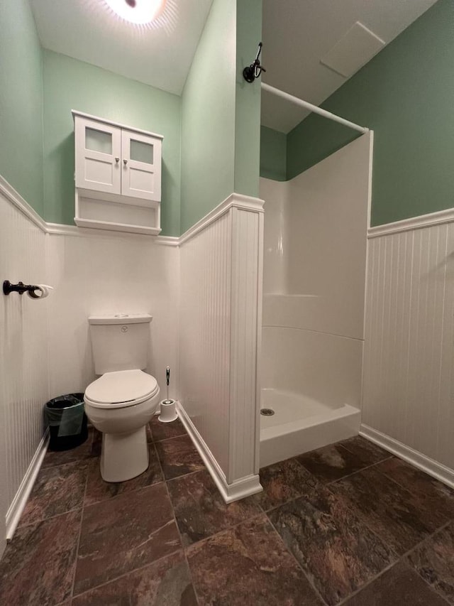 bathroom with toilet and walk in shower