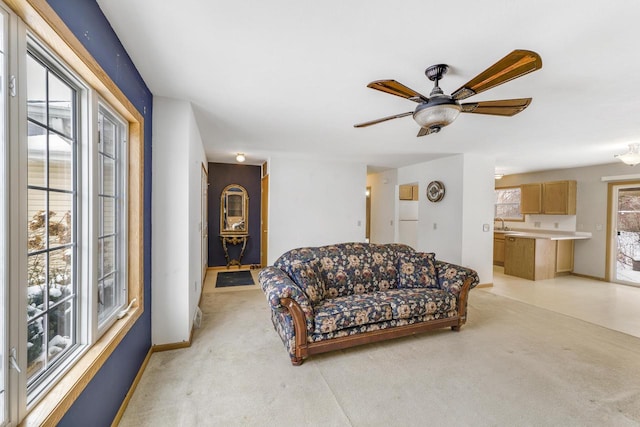 carpeted living room with ceiling fan