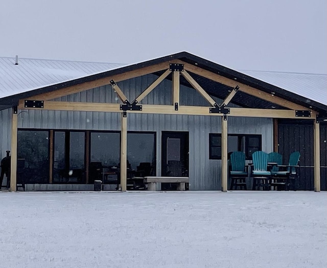 view of snow covered rear of property