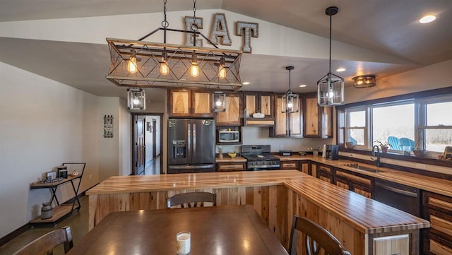 kitchen featuring pendant lighting, sink, stainless steel appliances, vaulted ceiling, and custom exhaust hood