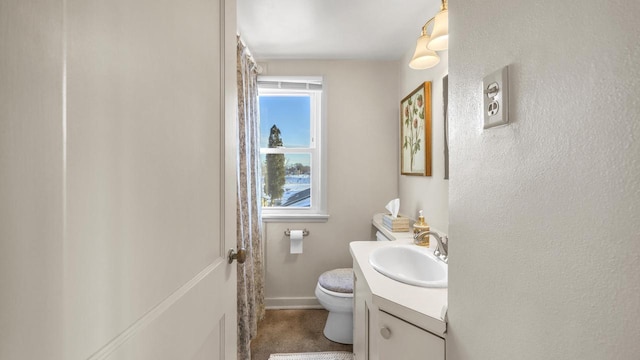 bathroom featuring vanity and toilet