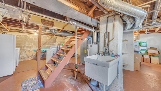 basement featuring sink, washer / dryer, and white refrigerator