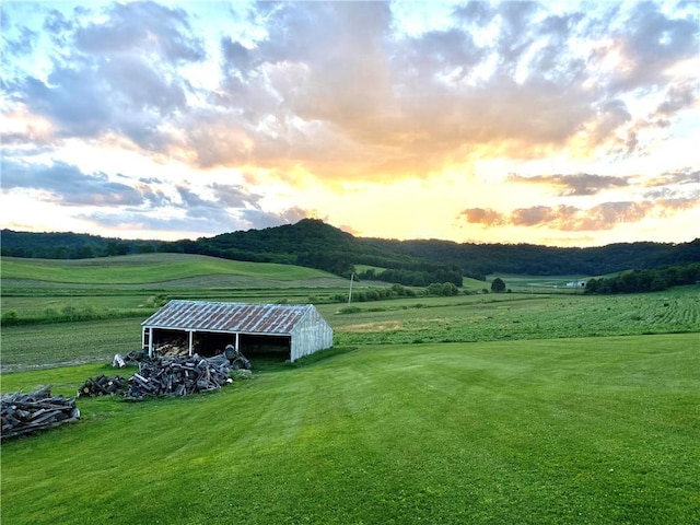 N19027 County Road F, Trempealeau, WI 54661 - yard at dusk featuring an outdoor structure, a pole building, and a rural view