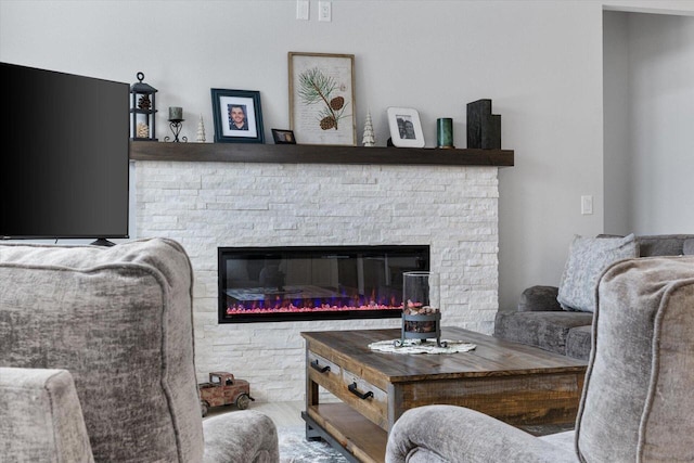 living room with a stone fireplace