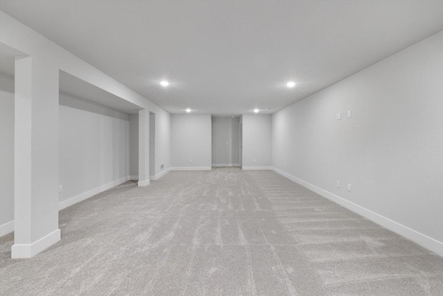 basement featuring light carpet