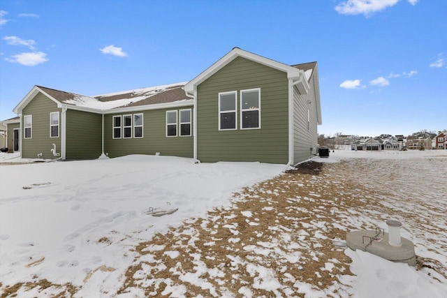 snow covered house with cooling unit