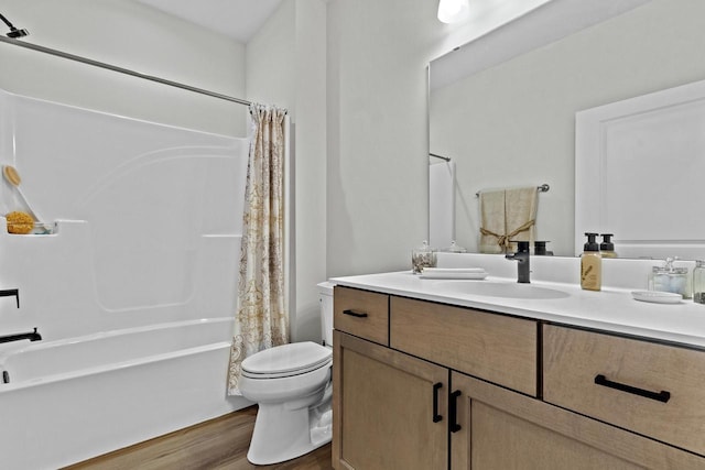 full bathroom featuring vanity, hardwood / wood-style floors, shower / bath combo, and toilet