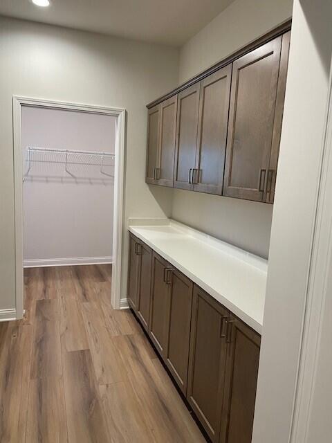 interior space featuring light hardwood / wood-style floors and dark brown cabinets