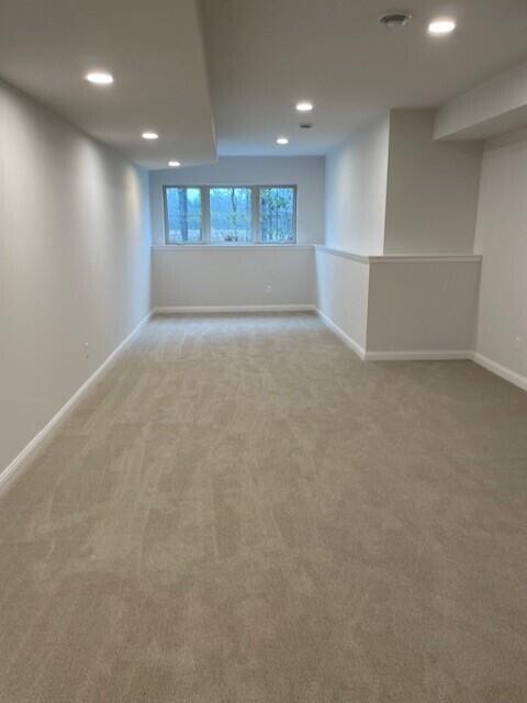 basement featuring light colored carpet