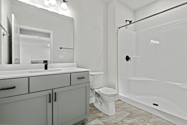 bathroom with vanity, toilet, and walk in shower