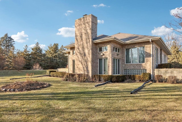 rear view of property featuring a yard