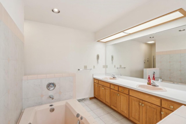 bathroom featuring vanity, a bath, and tile patterned floors
