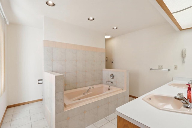 bathroom with vanity, a relaxing tiled tub, and tile patterned floors