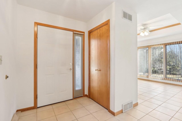 entrance foyer featuring light tile patterned flooring and ceiling fan