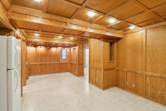 basement featuring white fridge, wooden ceiling, and wood walls