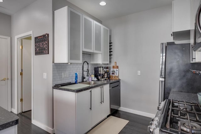 kitchen with dishwasher, gas range, sink, white cabinetry, and fridge