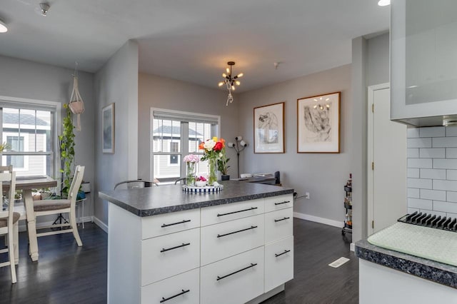 kitchen with white cabinetry, dark hardwood / wood-style floors, and a healthy amount of sunlight