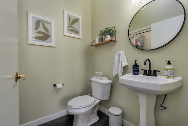 bathroom with wood-type flooring and toilet