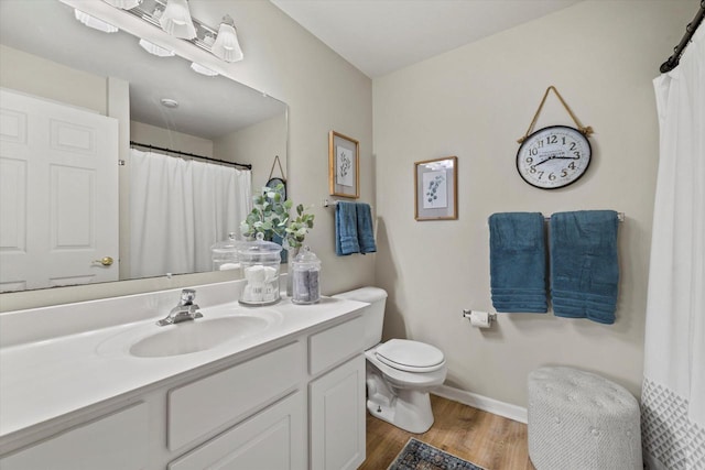 bathroom featuring vanity, hardwood / wood-style floors, and toilet