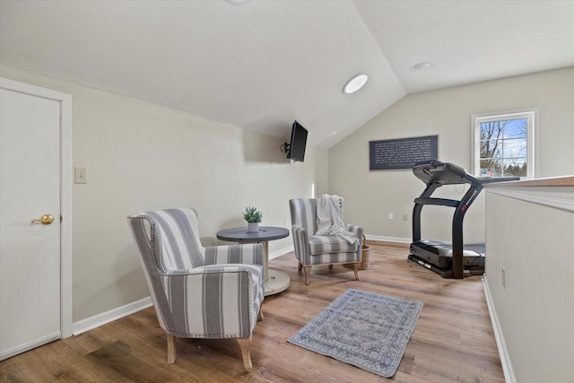 sitting room featuring vaulted ceiling and hardwood / wood-style floors