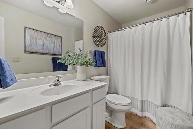 bathroom featuring vanity, hardwood / wood-style floors, and toilet