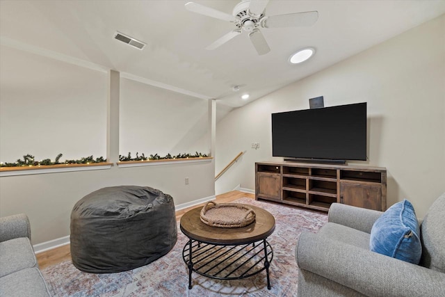 living room with ceiling fan, wood-type flooring, and vaulted ceiling