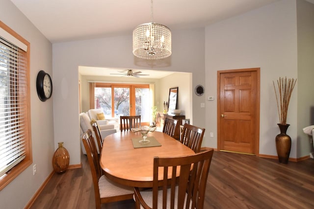 dining space with vaulted ceiling, dark wood-type flooring, and a chandelier