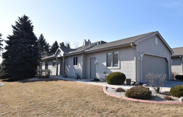 single story home featuring a garage and a front yard