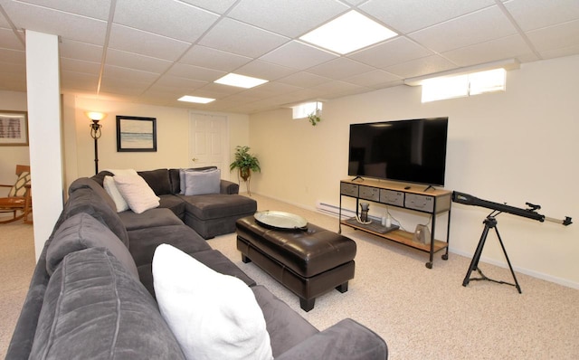 carpeted living room with a drop ceiling