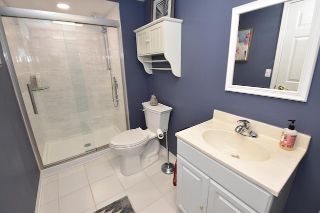 bathroom with vanity, tile patterned flooring, a shower with door, and toilet