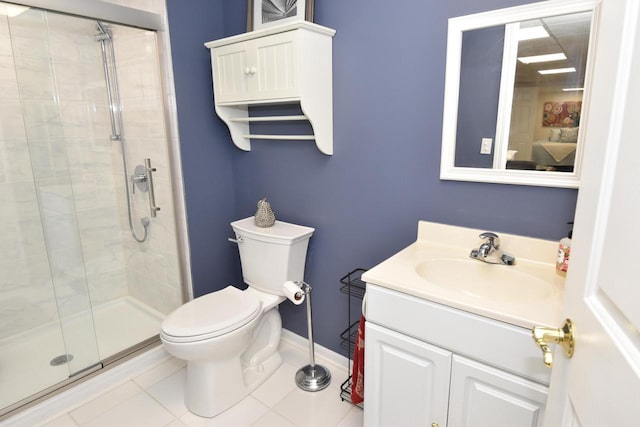 bathroom featuring vanity, tile patterned floors, toilet, and walk in shower