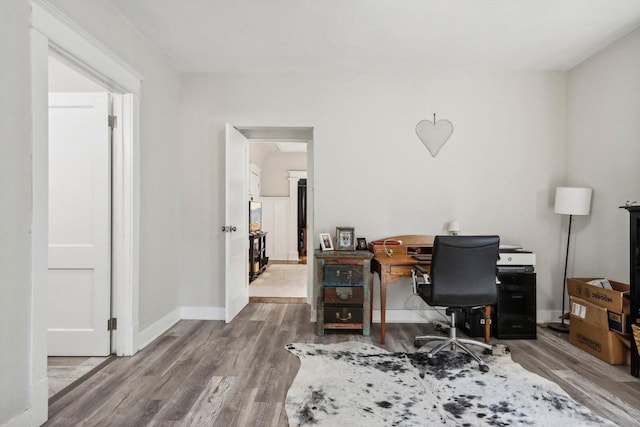 home office with wood-type flooring