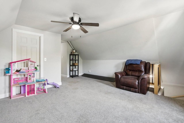 interior space featuring ceiling fan, light colored carpet, and vaulted ceiling