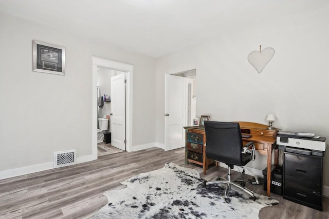 home office with hardwood / wood-style floors