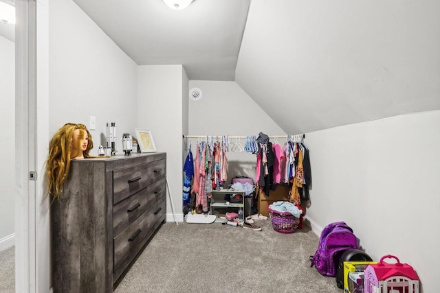 spacious closet featuring lofted ceiling and carpet flooring