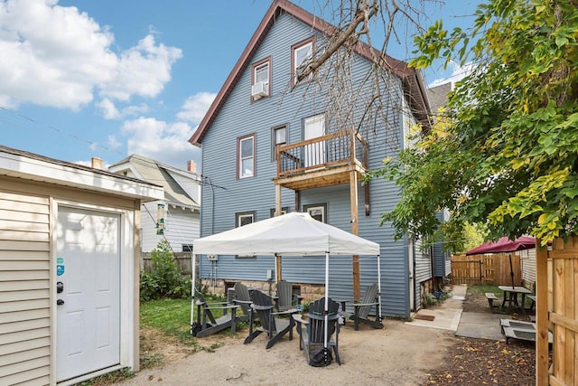 back of property featuring a gazebo