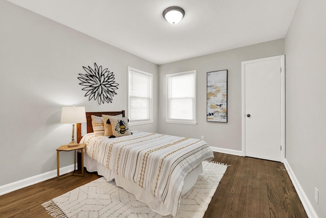 bedroom with dark wood-type flooring