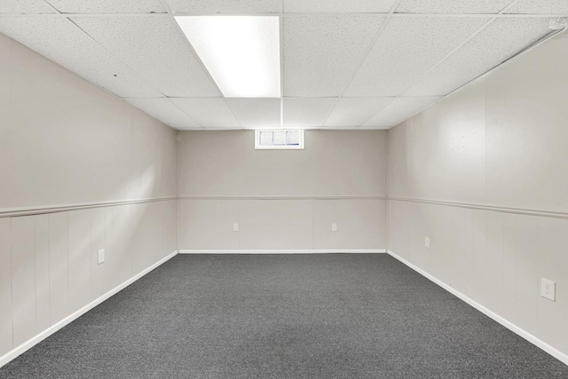 basement featuring carpet flooring and a drop ceiling