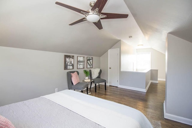 bedroom with dark hardwood / wood-style flooring, vaulted ceiling, and ceiling fan