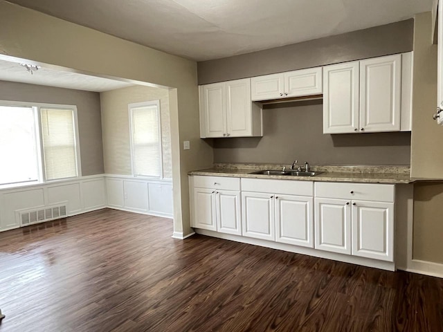 kitchen with white cabinetry, dark hardwood / wood-style flooring, and sink