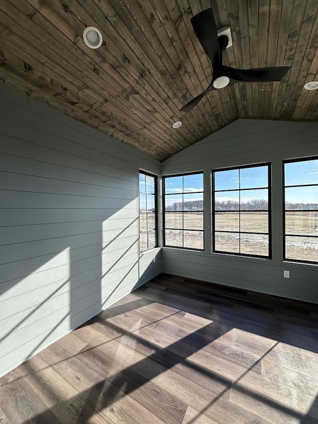 unfurnished sunroom with ceiling fan, lofted ceiling, a wealth of natural light, and wood ceiling