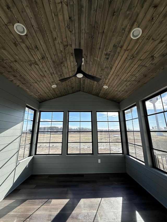 unfurnished sunroom featuring lofted ceiling, wood ceiling, a wealth of natural light, and ceiling fan