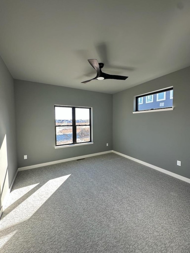 spare room featuring carpet flooring and ceiling fan