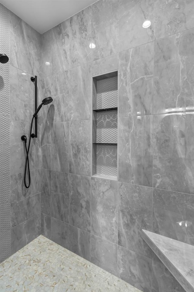 bathroom with a tile shower