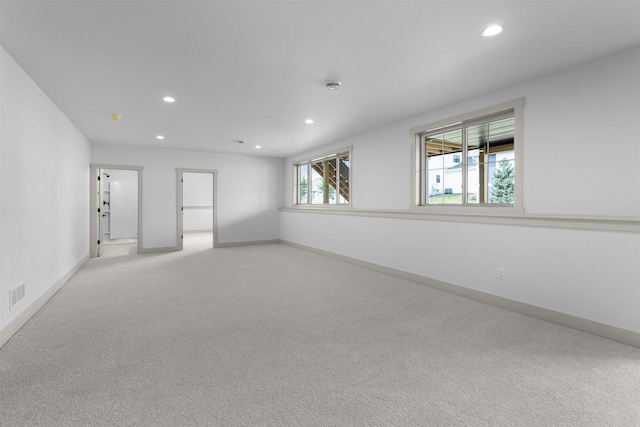 unfurnished room with light colored carpet