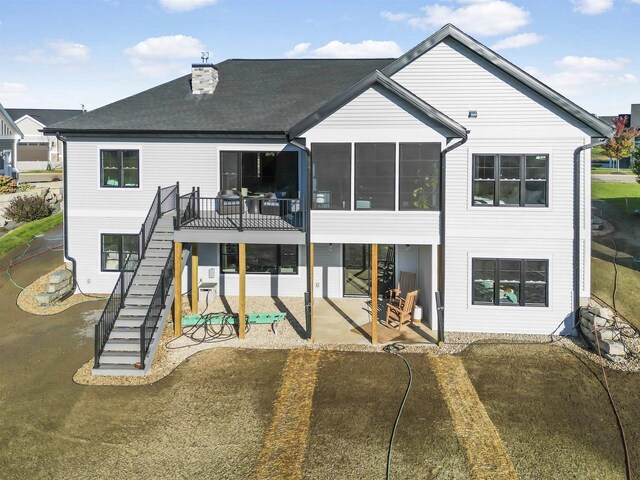 822 Westbridge Trl, Waunakee, WI 53597 - rear view of house featuring a sunroom, a patio, and a lawn