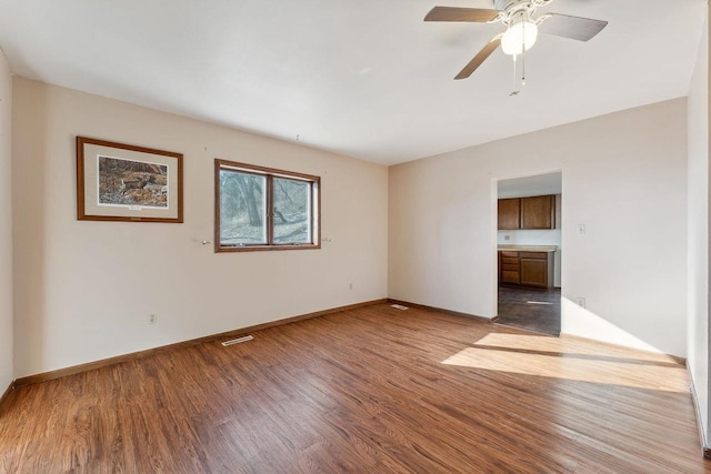 empty room featuring ceiling fan and light wood-type flooring