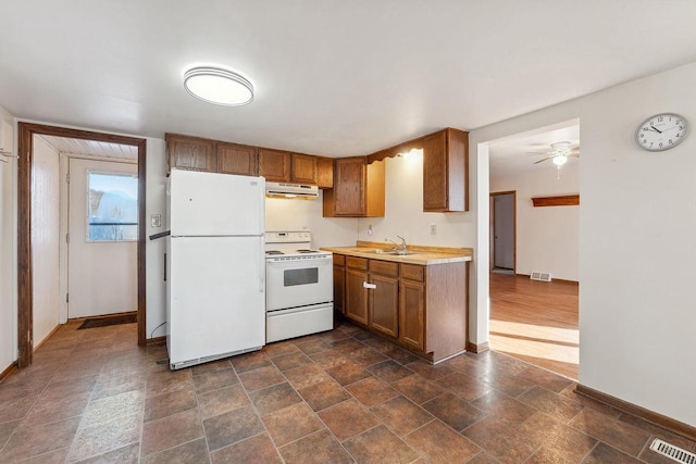 kitchen with sink, white appliances, and ceiling fan