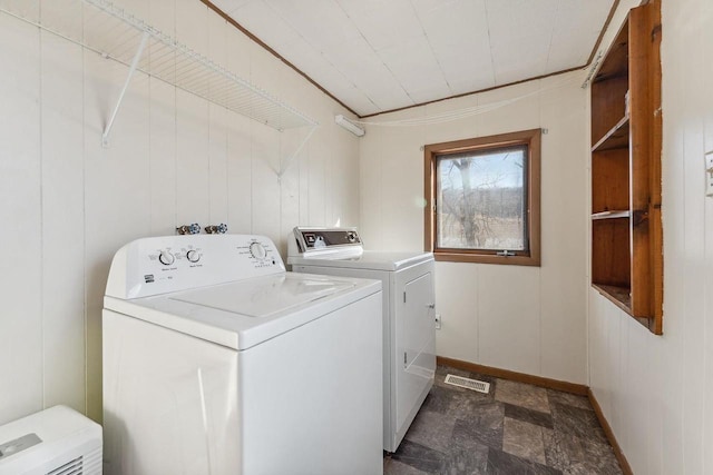 clothes washing area with washing machine and clothes dryer