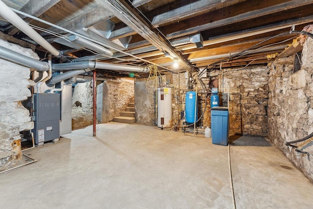 basement featuring heating unit and electric water heater